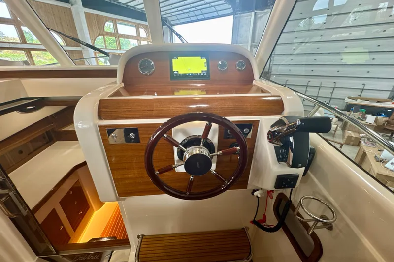  Yacht Photos Pics 2024 DaVinci 30HT boat helm with wooden dashboard and modern controls.