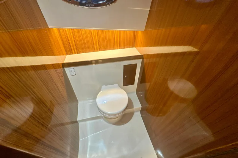  Yacht Photos Pics Luxurious bathroom interior of 2024 DaVinci 30HT yacht with wood paneling.