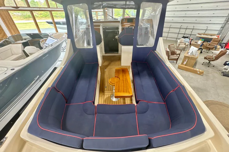  Yacht Photos Pics 2024 DaVinci 30HT boat interior with blue seating and wooden table.