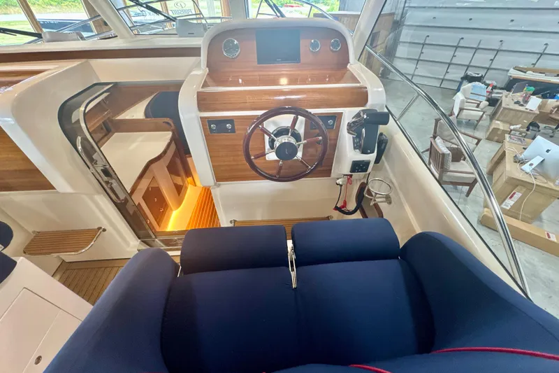  Yacht Photos Pics 2024 DaVinci 30HT boat interior with wooden dashboard and blue seating.
