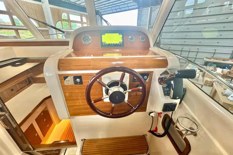  Yacht Photos Pics 2024 DaVinci 30HT boat helm with wooden dashboard and modern controls.