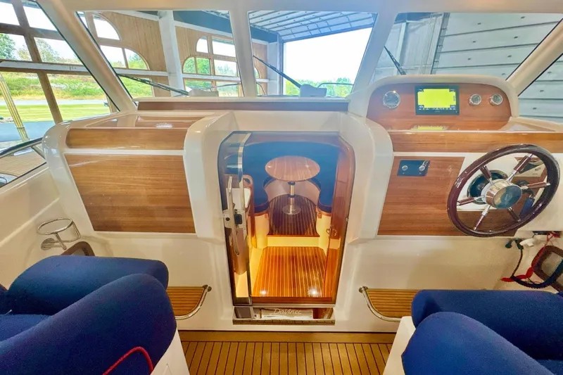  Yacht Photos Pics Interior of 2024 DaVinci 30HT boat with wooden accents and modern controls.