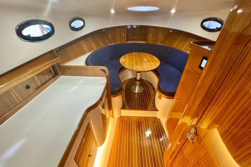  Yacht Photos Pics Luxurious 2024 DaVinci 30HT yacht interior with elegant wood finish and cozy seating area.