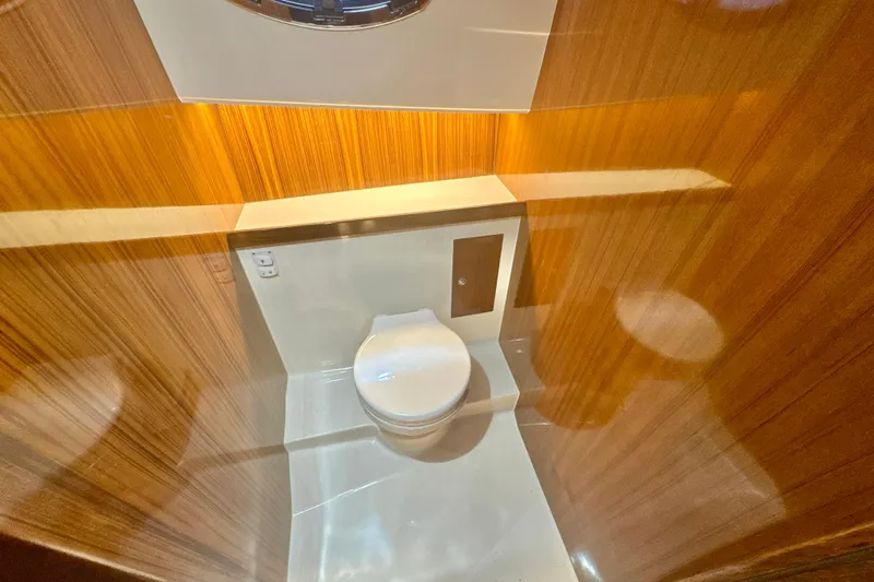  Yacht Photos Pics Luxurious bathroom interior of 2024 DaVinci 30HT yacht with wooden paneling.