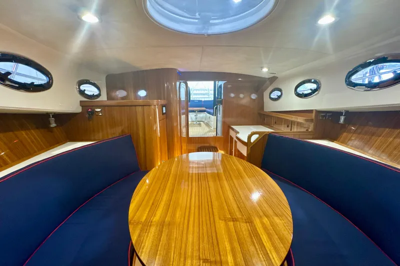 Yacht Photos Pics Luxurious interior of 2024 DaVinci 30HT yacht with polished wood and elegant seating.