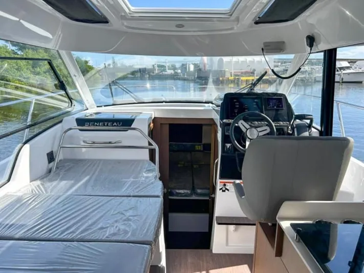  Yacht Photos Pics Interior of 2025 Beneteau Antares 9 boat, featuring helm and seating area.