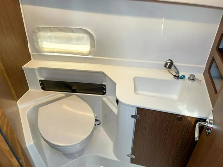  Yacht Photos Pics 2025 Beneteau Antares 9 bathroom with modern fixtures and compact design.