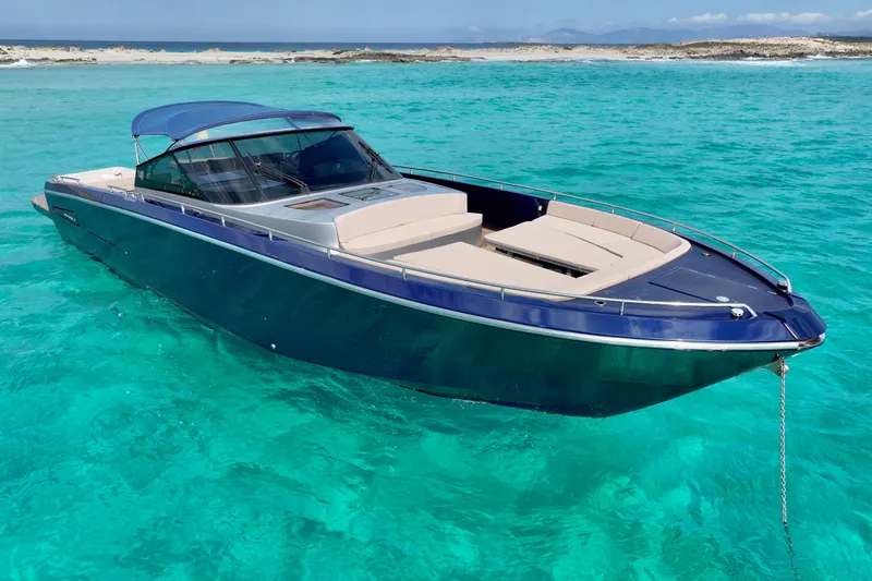 Double K Yacht Photos Pics Luxurious 2010 CNM CONTINENTAL TENDER 50 yacht on turquoise waters near sandy shore.