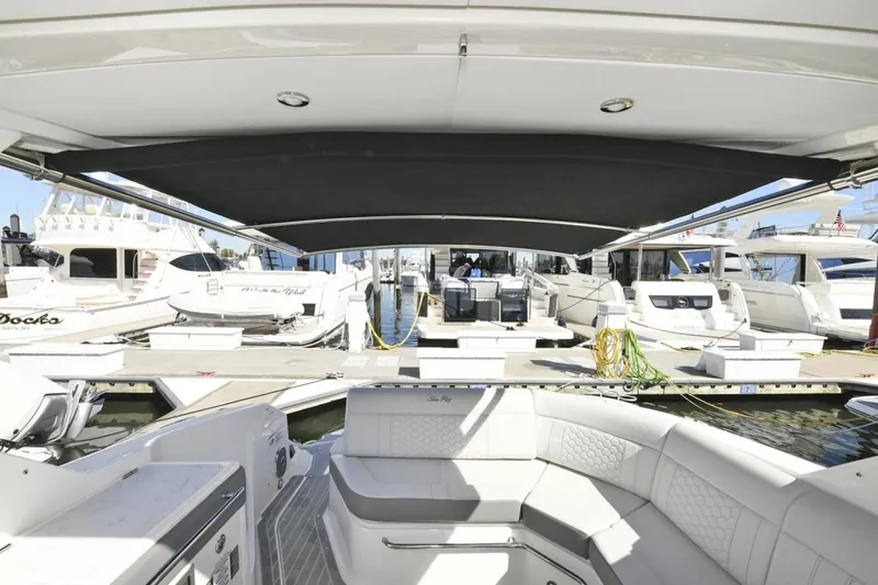  Yacht Photos Pics 2022 Sea Ray Sundancer 320 yacht interior with docked boats in marina.