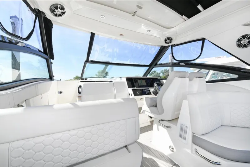  Yacht Photos Pics 2022 Sea Ray Sundancer 320 interior with luxurious white seating and modern dashboard.
