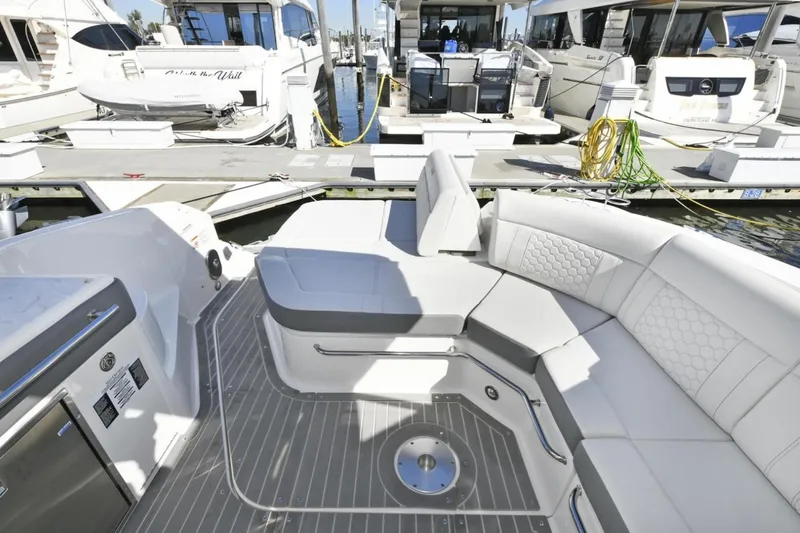  Yacht Photos Pics 2022 Sea Ray Sundancer 320 yacht interior with luxurious seating at marina.