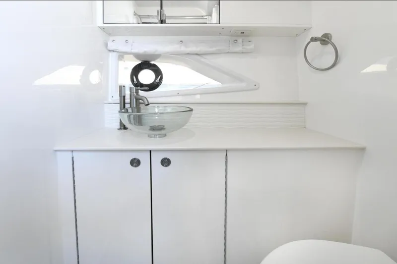  Yacht Photos Pics Modern bathroom interior of 2022 Sea Ray Sundancer 320 yacht with glass sink.