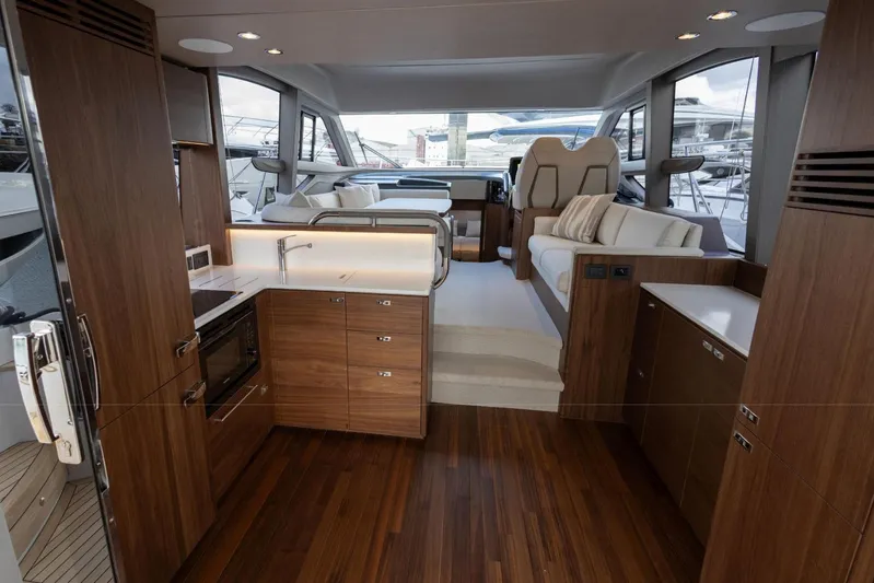  Yacht Photos Pics Luxurious interior of 2025 Princess F50 yacht with modern wood finishes and elegant seating.