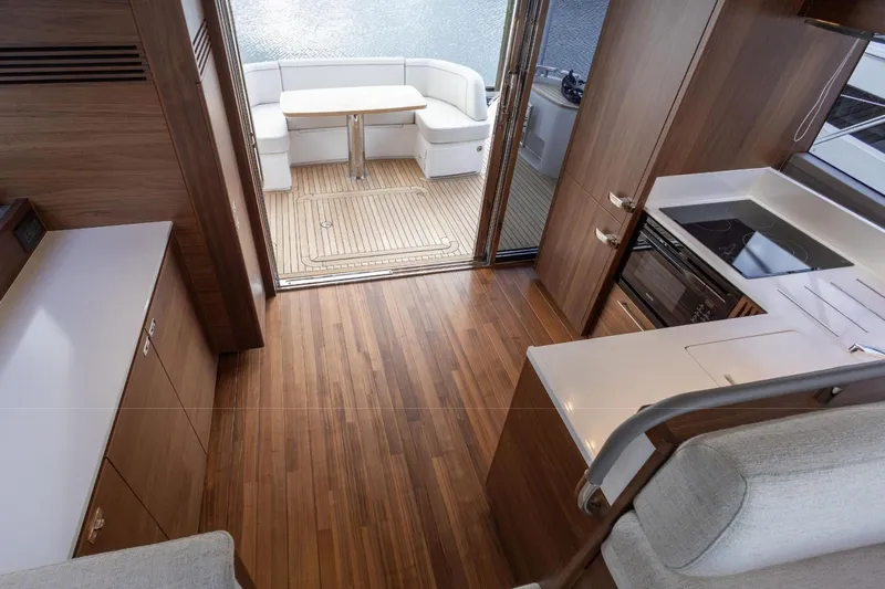  Yacht Photos Pics Interior of 2025 Princess F50 yacht with modern kitchen and seating area.