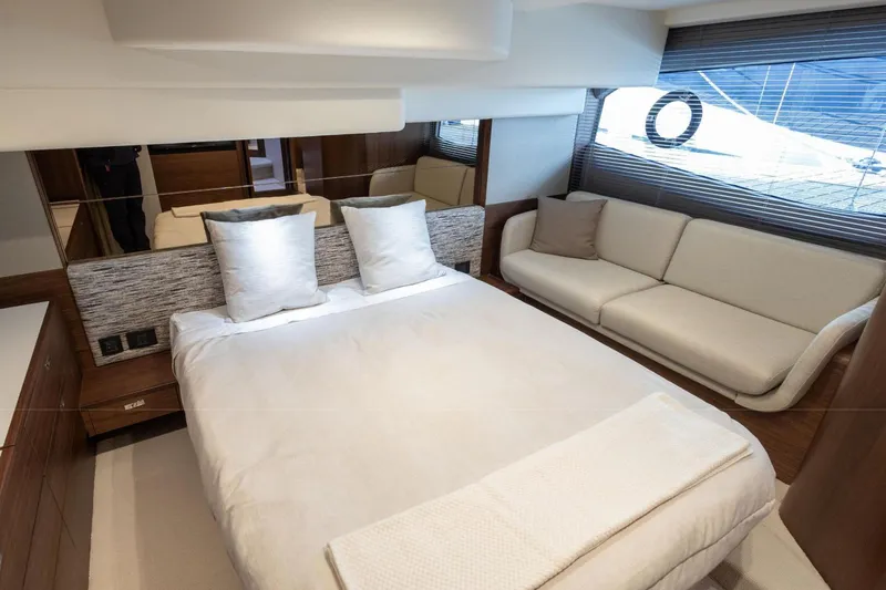  Yacht Photos Pics Luxurious bedroom interior of 2025 Princess F50 yacht with modern design and cozy seating.
