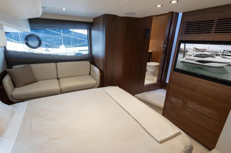  Yacht Photos Pics Luxurious interior of 2025 Princess F50 yacht with modern furnishings and scenic window view.