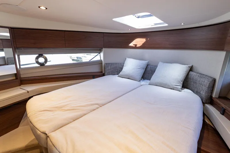  Yacht Photos Pics Luxurious interior cabin of 2025 Princess F50 yacht with modern design and comfortable bedding.