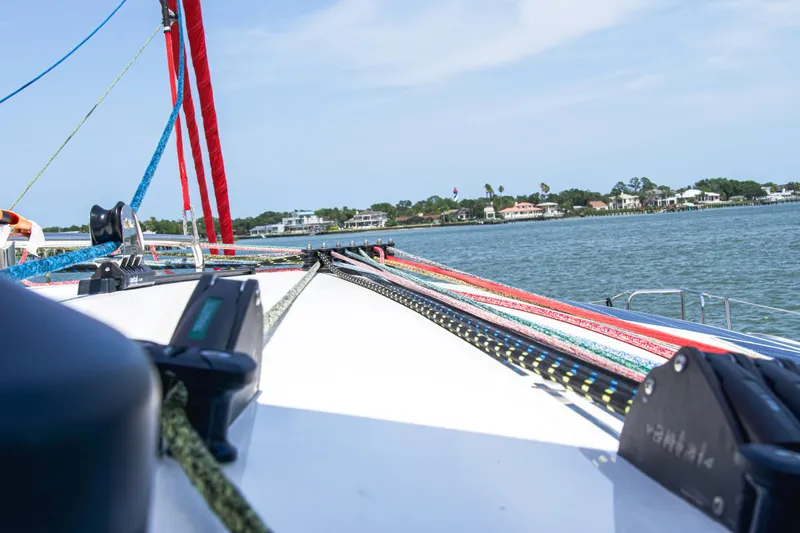 Out Of The Woods Yacht Photos Pics Deck of a NEEL 51 trimaran with colorful ropes, 2022 model.