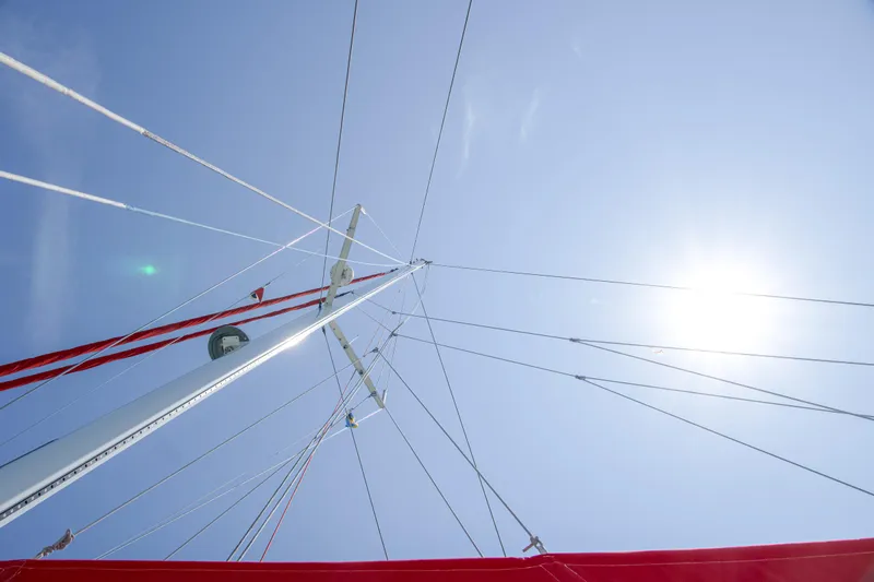 Out Of The Woods Yacht Photos Pics Sail mast of NEEL 51 under blue sky, 2022.