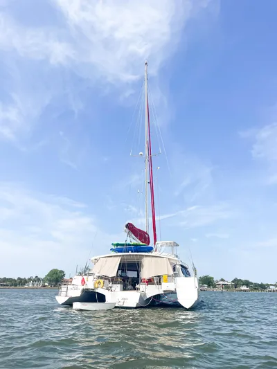 Out Of The Woods Yacht Photos Pics NEEL 51 trimaran on calm water, 2022 model.