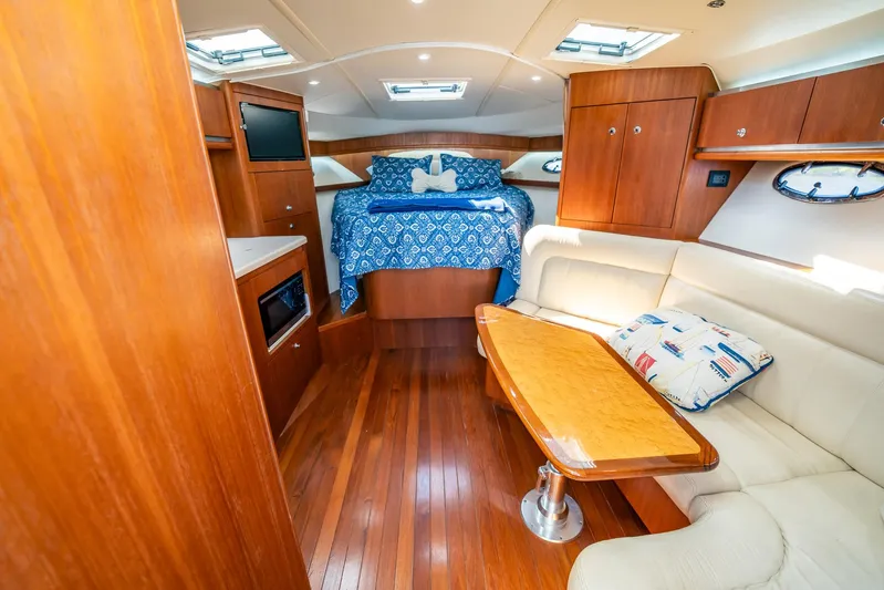 Maggie Yacht Photos Pics Luxurious interior of 2005 Tiara Yachts 3200 Open with wood finish and cozy seating.