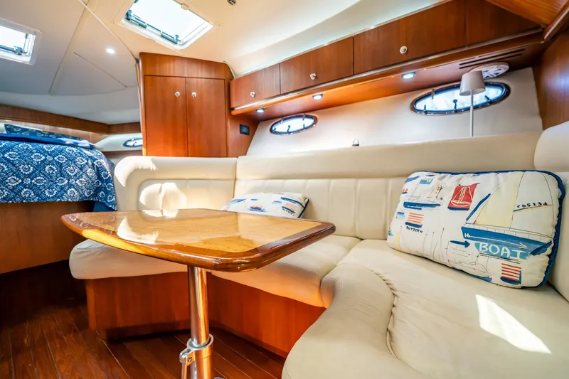 Maggie Yacht Photos Pics Luxurious interior of 2005 Tiara Yachts 3200 Open with plush seating and nautical decor.