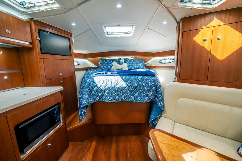 Maggie Yacht Photos Pics Luxurious 2005 Tiara Yachts 3200 Open cabin interior with cozy bed and modern amenities.