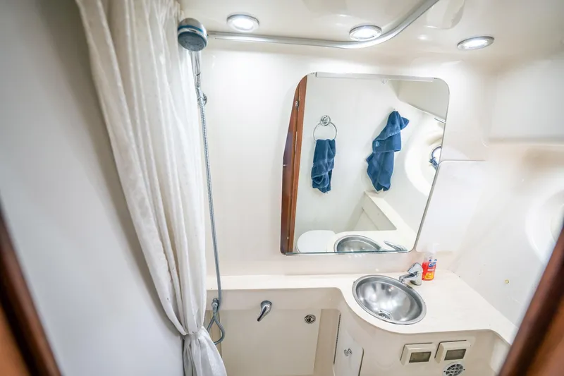 Maggie Yacht Photos Pics 2005 Tiara Yachts 3200 Open bathroom with shower, sink, and mirror.