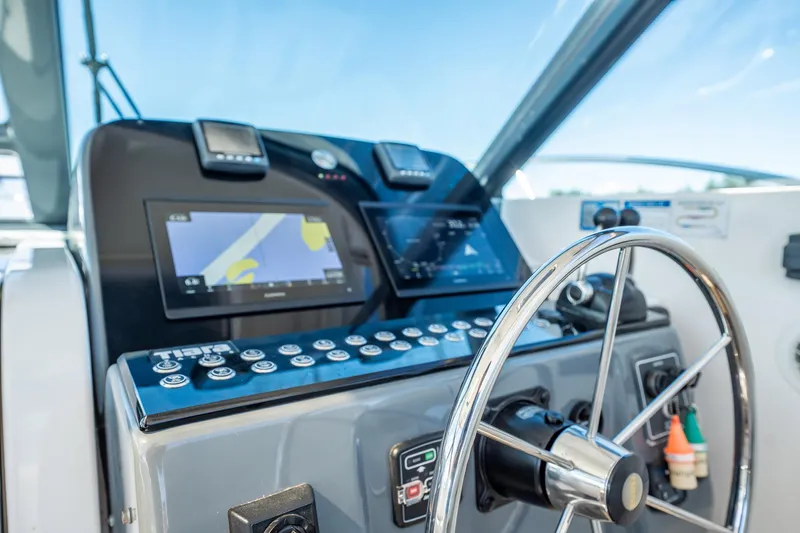 Maggie Yacht Photos Pics Helm of 2005 Tiara Yachts 3200 Open with navigation displays and steering wheel.