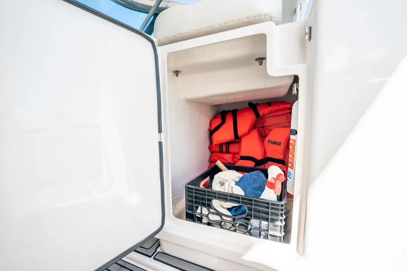 Maggie Yacht Photos Pics Storage compartment on 2005 Tiara Yachts 3200 Open with life jackets and cleaning supplies.