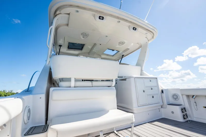 Maggie Yacht Photos Pics 2005 Tiara Yachts 3200 Open boat interior with seating and storage under clear blue sky.