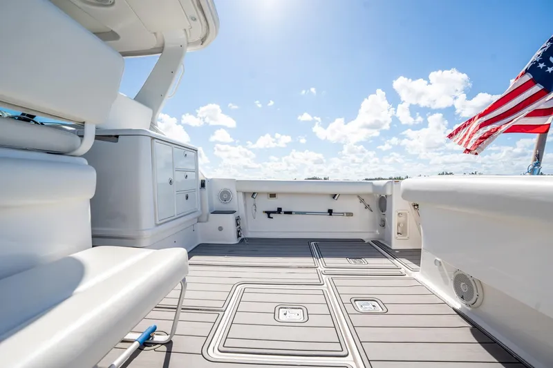 Maggie Yacht Photos Pics 2005 Tiara Yachts 3200 Open deck with American flag, clear sky background.