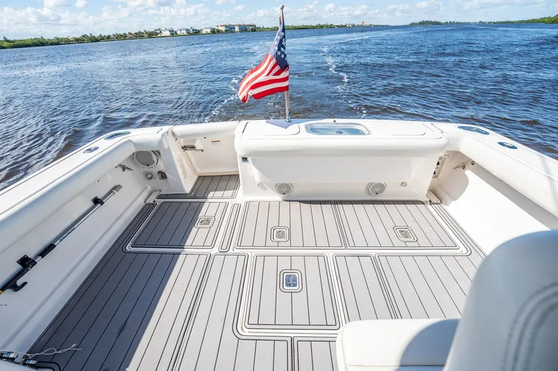 Maggie Yacht Photos Pics 2005 Tiara Yachts 3200 Open boat deck with American flag on open water.
