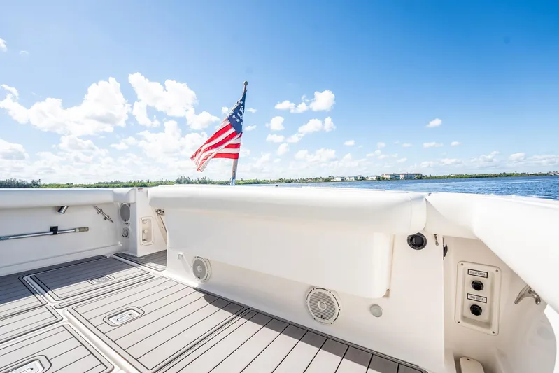 Maggie Yacht Photos Pics 2005 Tiara Yachts 3200 Open deck with American flag, clear sky, and water view.