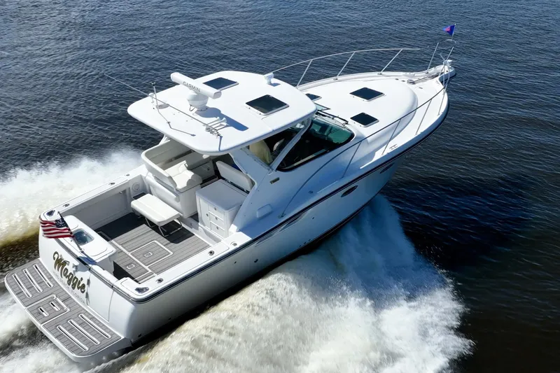 Maggie Yacht Photos Pics 2005 Tiara Yachts 3200 Open cruising on water, rear view, American flag displayed.