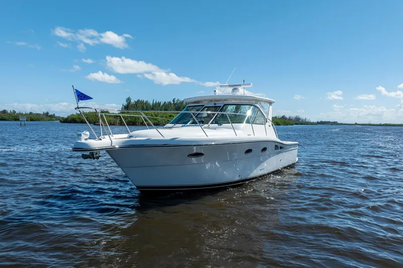 Maggie Yacht Photos Pics 2005 Tiara Yachts 3200 Open cruising on a sunny day, blue sky, calm waters.
