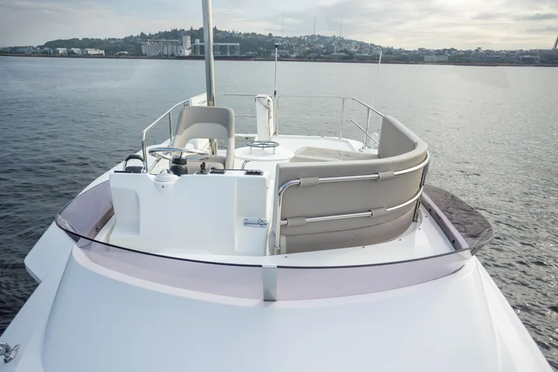 Everything Is Fine Yacht Photos Pics 2019 Beneteau Swift Trawler 30 flybridge with seating, overlooking calm waters.
