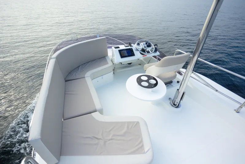 Everything Is Fine Yacht Photos Pics 2019 Beneteau Swift Trawler 30 flybridge with seating and helm, cruising on calm waters.