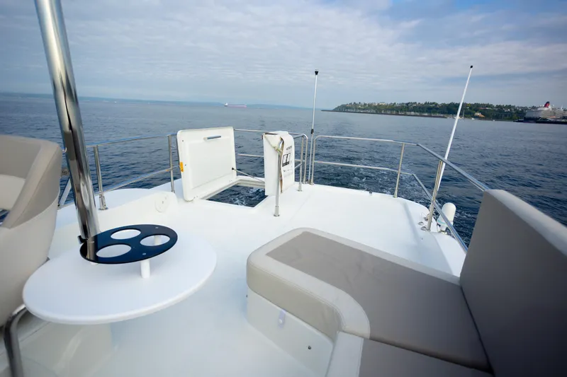 Everything Is Fine Yacht Photos Pics 2019 Beneteau Swift Trawler 30 deck view with ocean and distant shoreline.