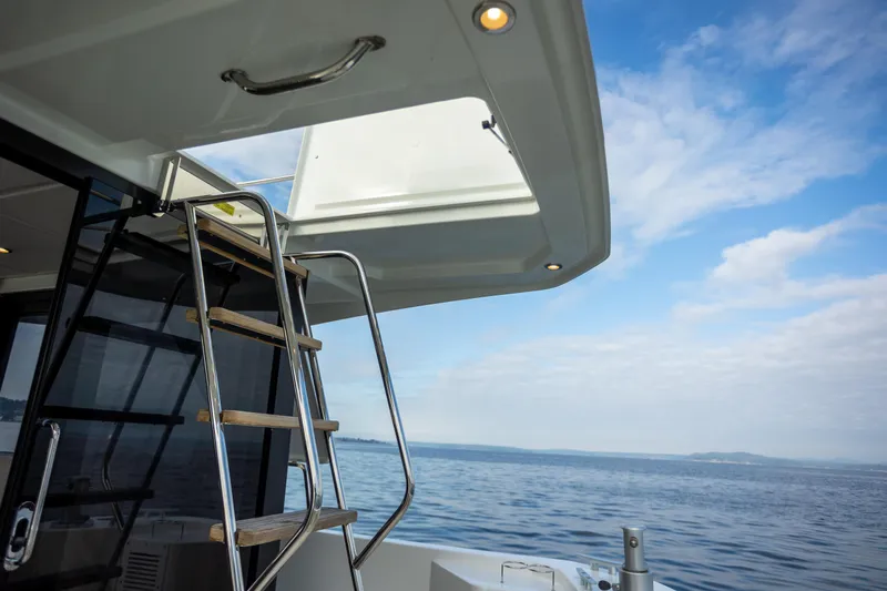 Everything Is Fine Yacht Photos Pics 2019 Beneteau Swift Trawler 30, ladder view, open sea, blue sky background.