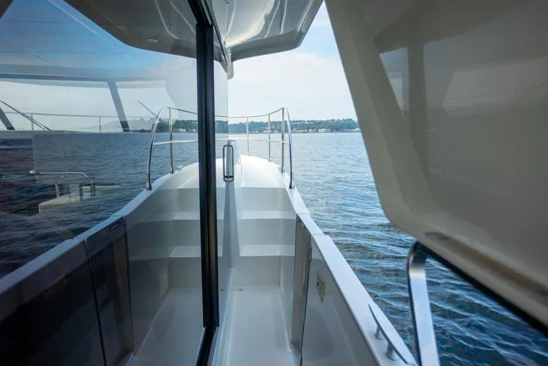 Everything Is Fine Yacht Photos Pics 2019 Beneteau Swift Trawler 30, side deck view over calm waters.