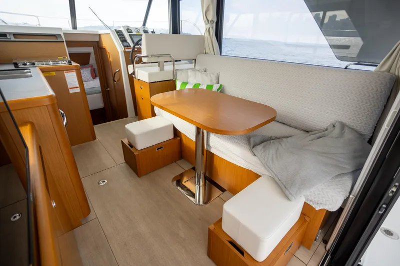 Everything Is Fine Yacht Photos Pics Interior of 2019 Beneteau Swift Trawler 30 with cozy seating and wooden table.