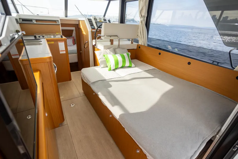 Everything Is Fine Yacht Photos Pics 2019 Beneteau Swift Trawler 30 interior with bed, wooden finish, and ocean view.