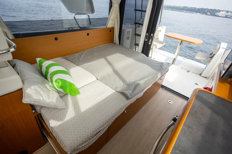 Everything Is Fine Yacht Photos Pics 2019 Beneteau Swift Trawler 30 interior with bed and view of the water.