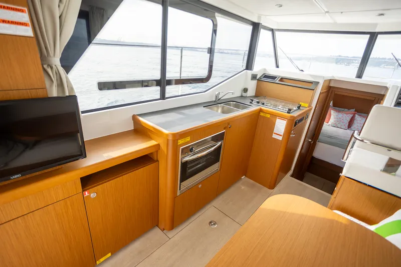 Everything Is Fine Yacht Photos Pics Interior of 2019 Beneteau Swift Trawler 30, featuring modern kitchen and cozy cabin.