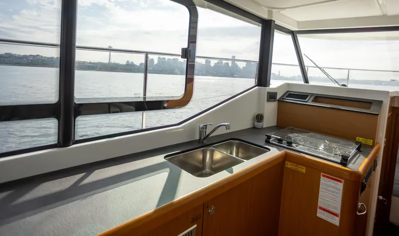 Everything Is Fine Yacht Photos Pics Interior of 2019 Beneteau Swift Trawler 30 with kitchenette and waterfront view.
