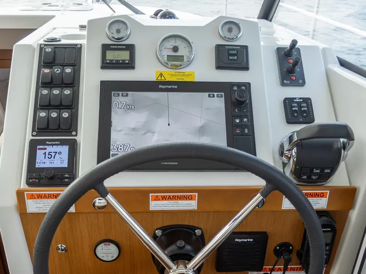 Everything Is Fine Yacht Photos Pics 2019 Beneteau Swift Trawler 30 helm with navigation controls and display.