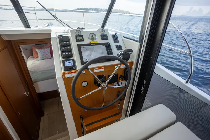 Everything Is Fine Yacht Photos Pics 2019 Beneteau Swift Trawler 30 helm with navigation equipment and cabin view.