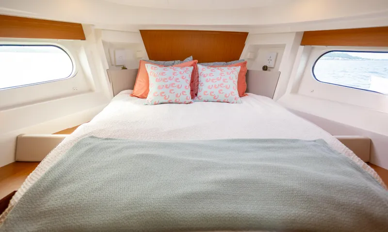 Everything Is Fine Yacht Photos Pics 2019 Beneteau Swift Trawler 30 cabin interior with cozy bed and decorative pillows.