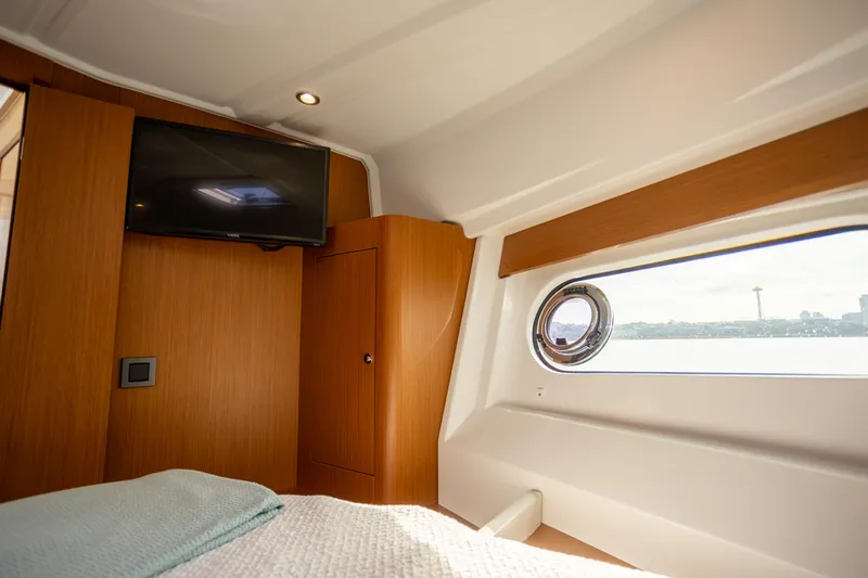 Everything Is Fine Yacht Photos Pics 2019 Beneteau Swift Trawler 30 cabin interior with TV and porthole view.